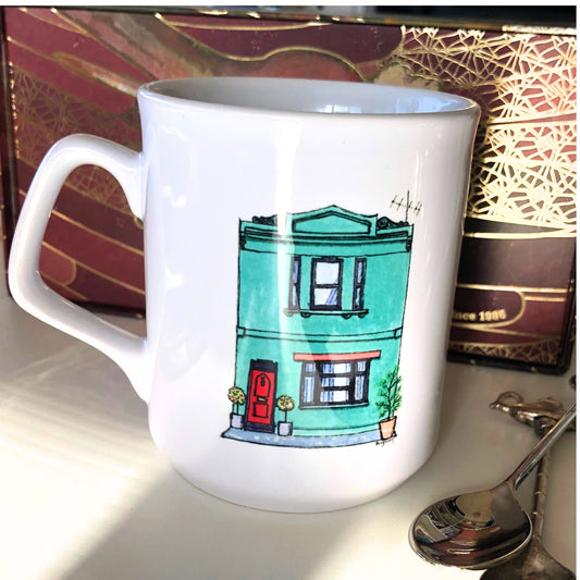 White coffee mug showing a watercoloured, jade, Australian, Victorian era terrace house.  From original artwork.