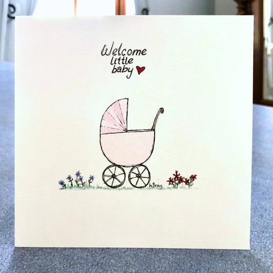 Square baby card, with an old fashioned pink pram with some flowers on the ground.