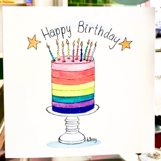 A rainbow cake with candles. The title reads "Happy Birthday" with two gold stars. From an original watercolour by Helen Gray.