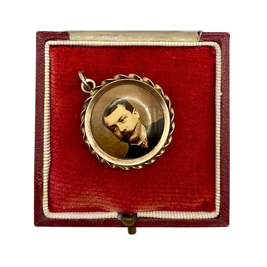 A double sided Austrian antique silver photo locket or pendant.
