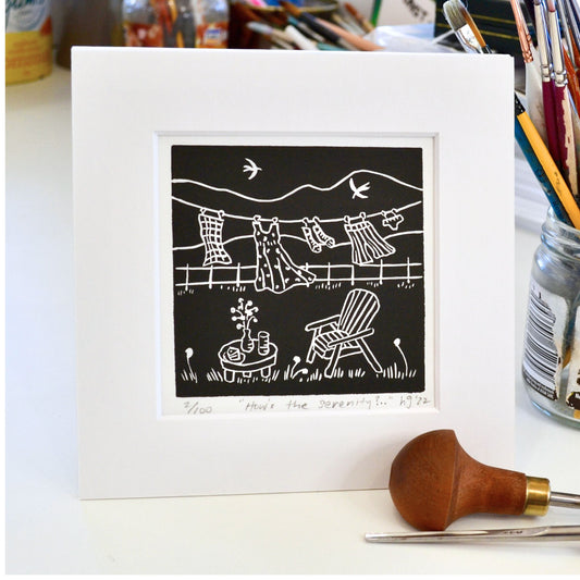 Lino print, How's the Serenity?... handprinted by Helen Gray. Chair and table outside with clothes hanging out.