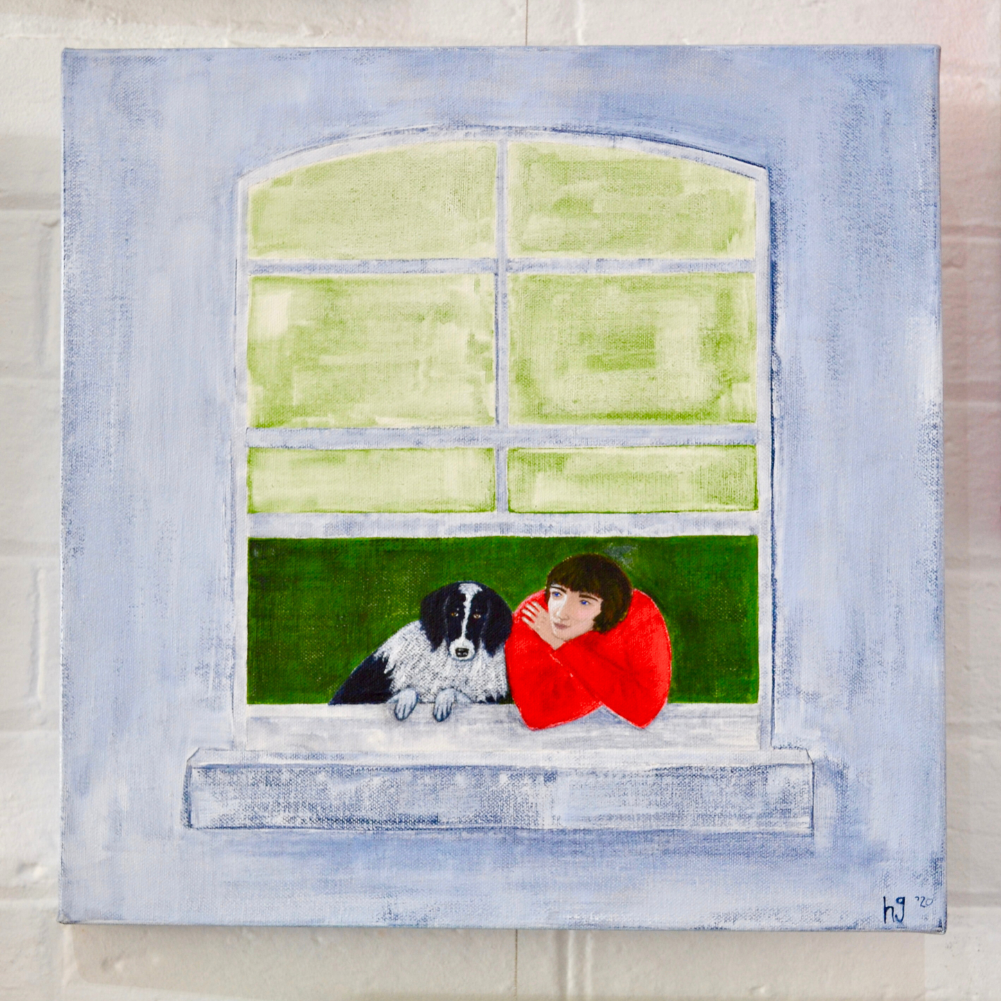A woman in a red jumper looking wistfully out her window with her black and white dog by her side. 