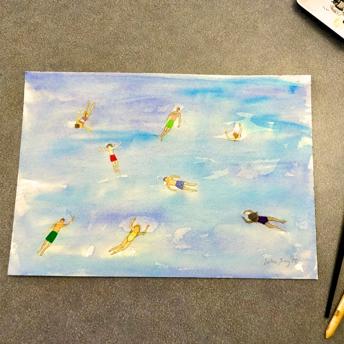 Original watercolour painting by Helen Gray depicting 8 swimmers in brightly coloured swim suits lazing in the open waters. An aerial view.