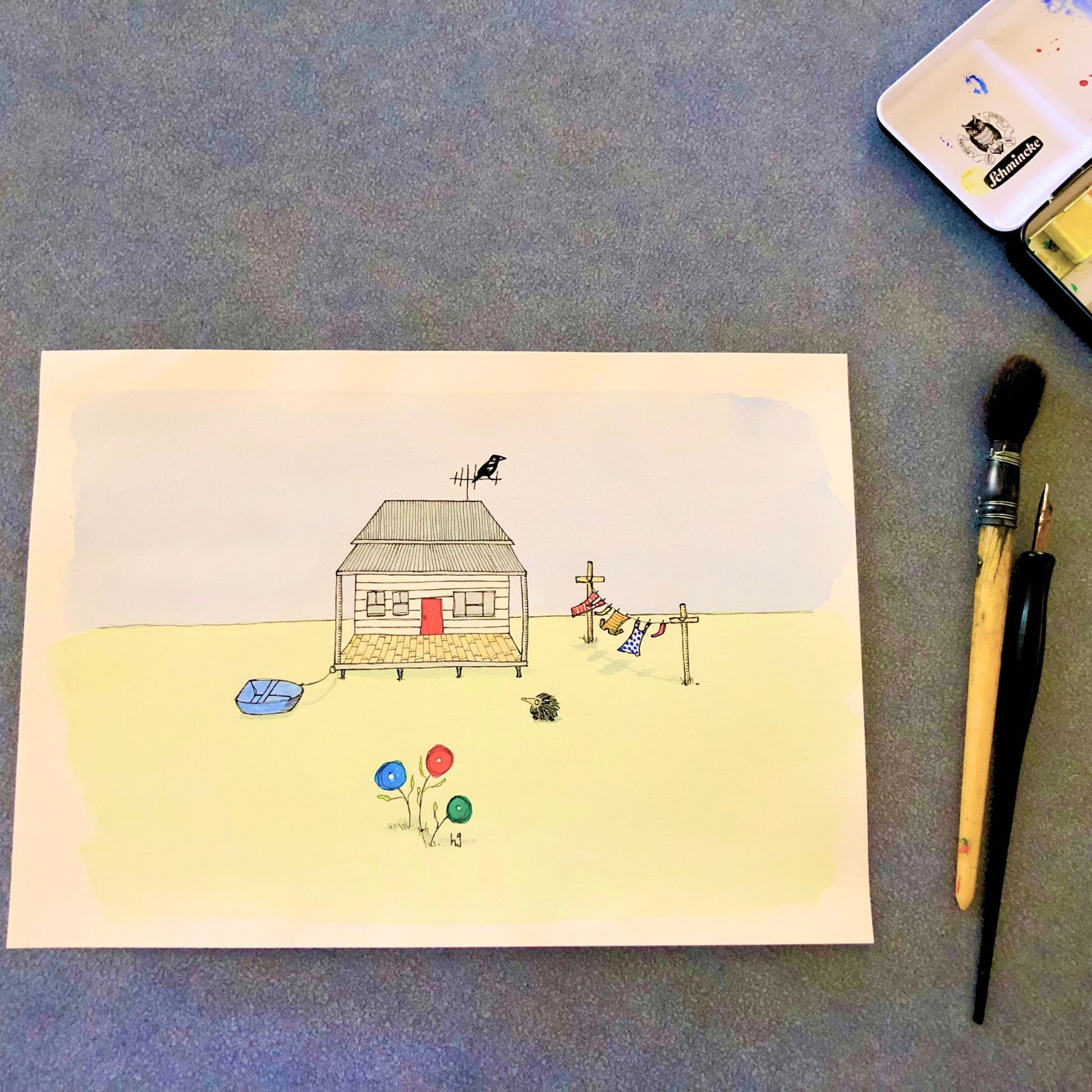 Original watercolour on paper by Helen Gray, depicting a small Australian cabin with a dingy tied to it, a clothesline with washing on it, and an echidna and magpie.