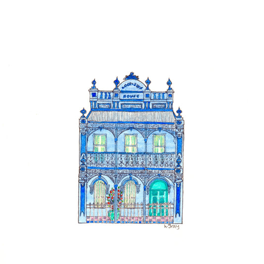 Old Australian blue terrace house, with ornate filigree and trim on verandah, and a turquoise door and flower pot. Printed using artist pigment on watercolour paper.